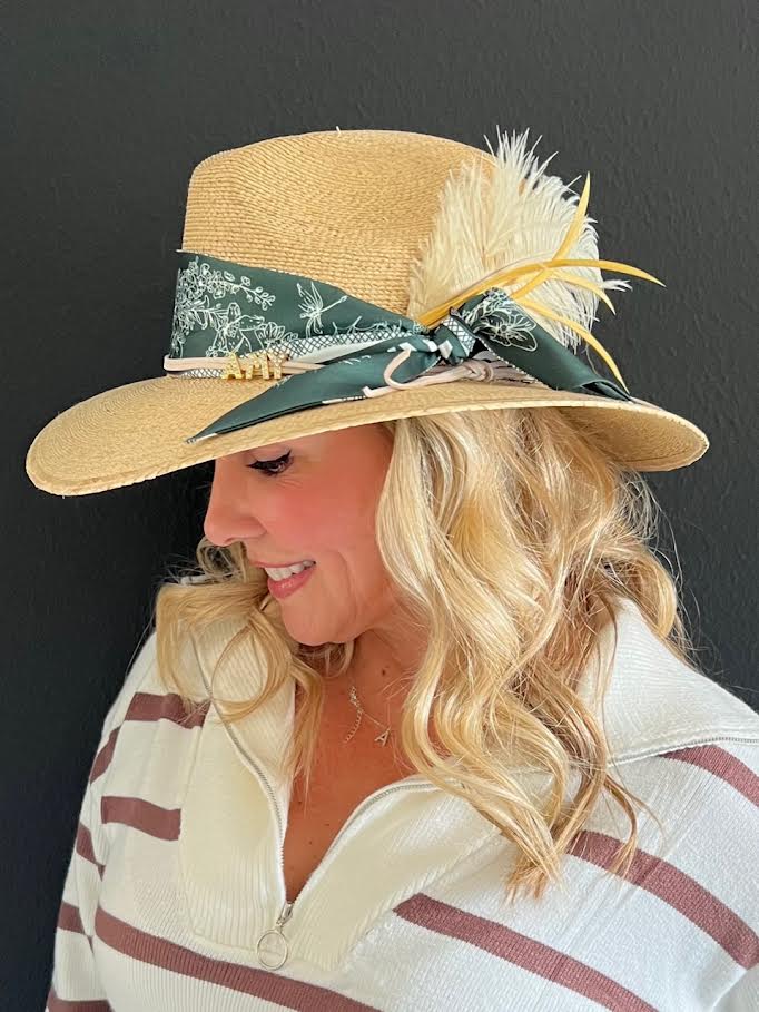 This is one of the many ways to build a hat! On this one we added a scarf, a suede band with my name and topped it with feathers!