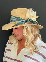 This is one of the many ways to build a hat! On this one we added a scarf, a suede band with my name and topped it with feathers!